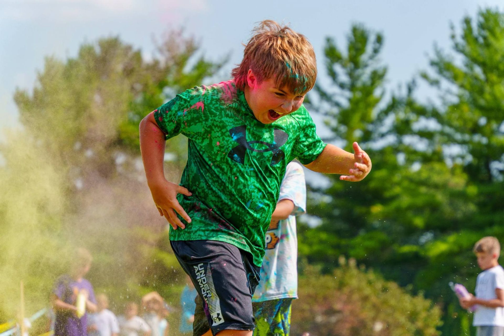 Participants covered in colored powder at the Community in Color Fun Run in Mendota