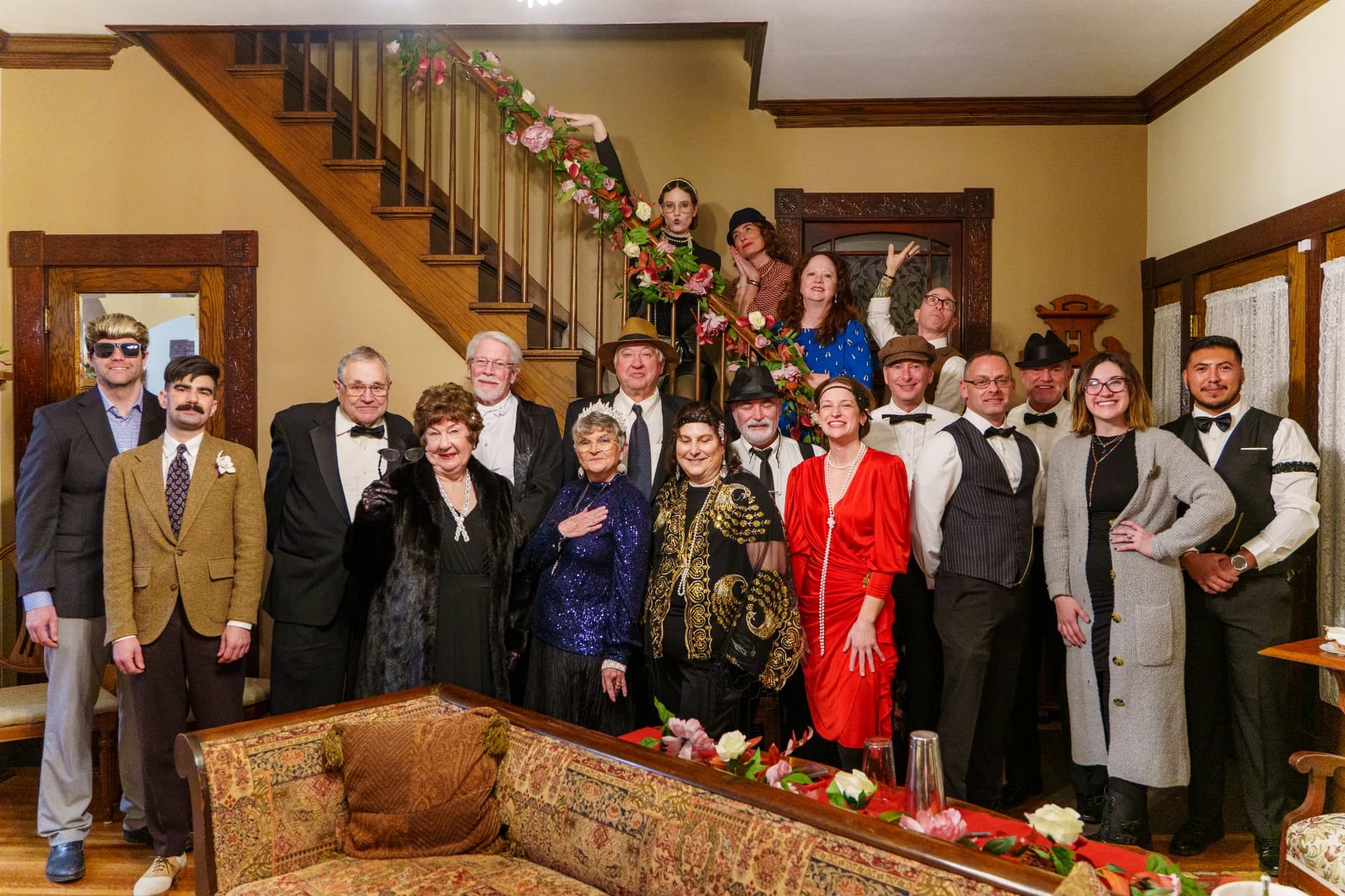 Supporters dressed in 1920s attire gathered on a staircase at a Live Well Mendota fundraising event